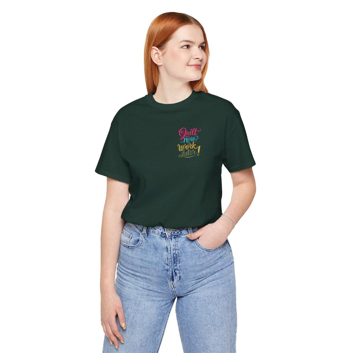 A Forest funny quilting T-shirt featuring bold, stylized text that reads "Quilt Now, Work Later" in various vibrant colors. The playful design captures the spirit of passionate quilters who prioritize their craft over other responsibilities.