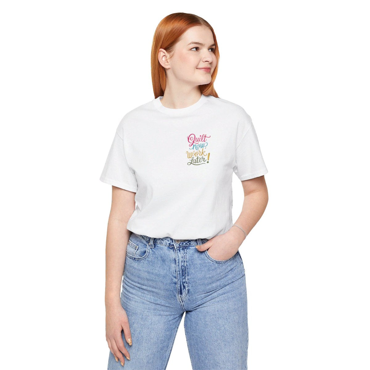 A White funny quilting T-shirt featuring bold, stylized text that reads "Quilt Now, Work Later" in various vibrant colors. The playful design captures the spirit of passionate quilters who prioritize their craft over other responsibilities.