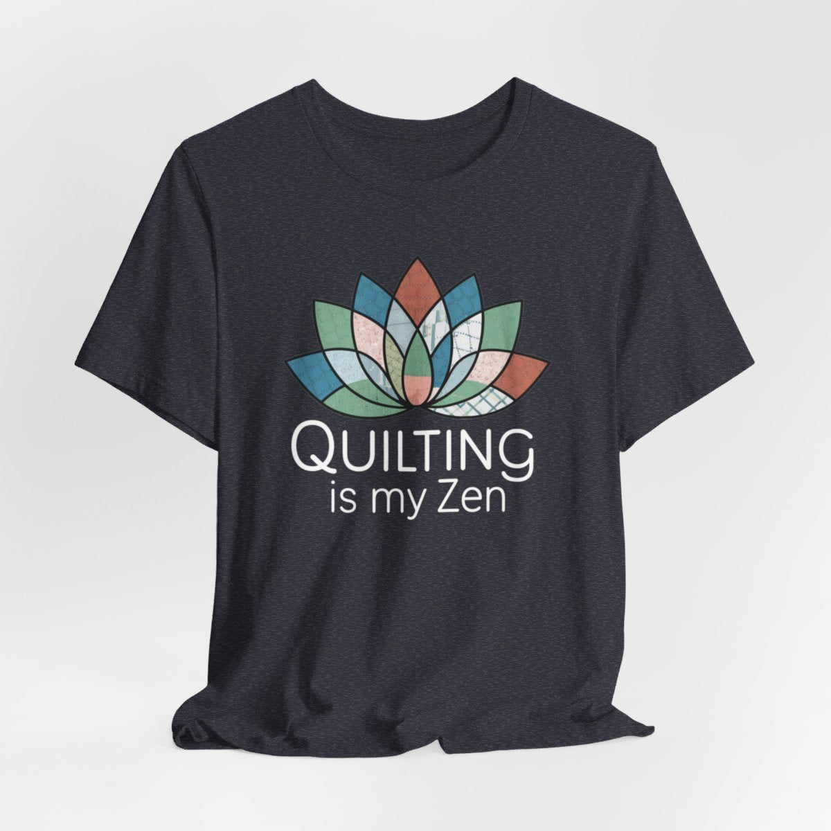 A Heather Navy funny quilting T-Shirt with the phrase Quilting is my Zen on a quilting-themed t-shirt with a lotus flower design made of various quilt patterns and textures. 