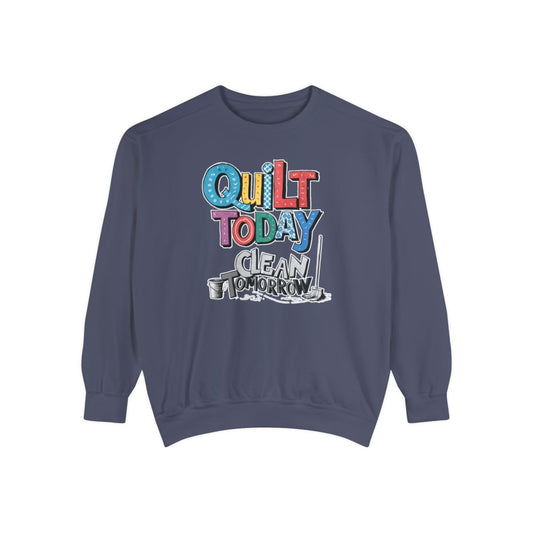 A Denim funny Sweatshirt with the phrase Quilt Today, Clean Tomorrow in a bold and cheerful font with a broom off to the side