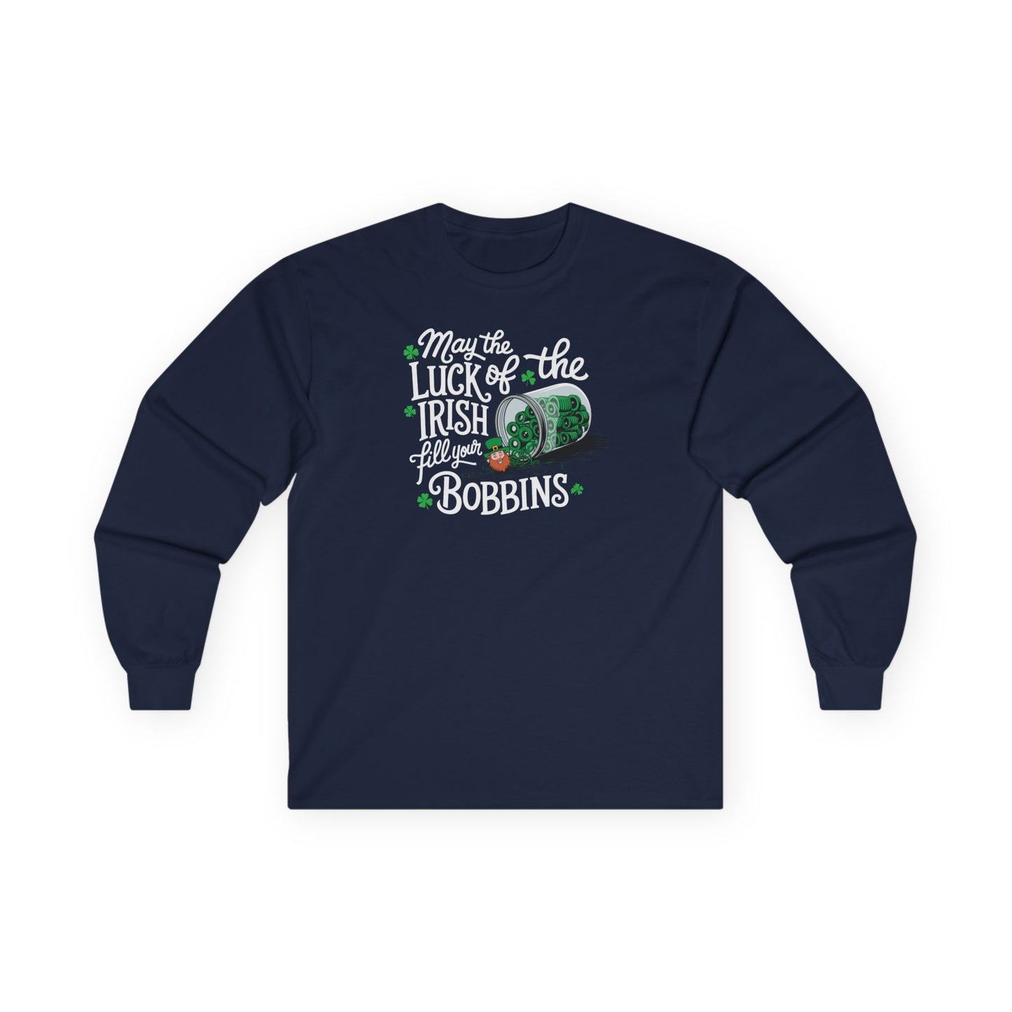 A Navy long-sleeve t-shirt featuring a festive design with shamrocks, a spool of green thread, and the phrase 'May the Luck of the Irish Fill Your Bobbins,' perfect for quilters celebrating St. Patrick’s Day.