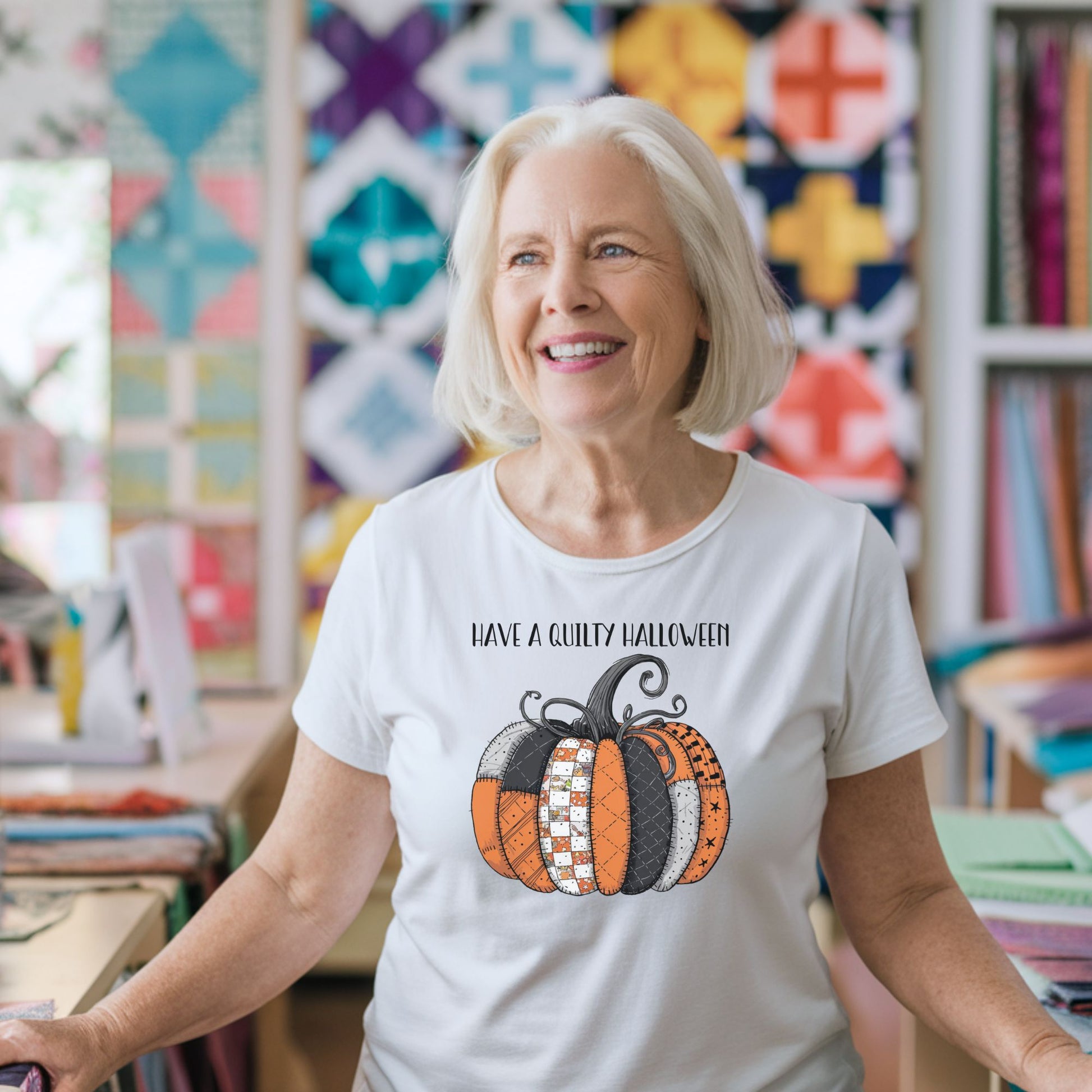 A Halloween Quilting T-Shirt featuring patchwork pumpkin with various quilt patterns. Mix of Halloween and traditional quilt motifs. Intricate stitching details. Text reads "Have a Quilty Halloween". Ideal for quilters who love Halloween.