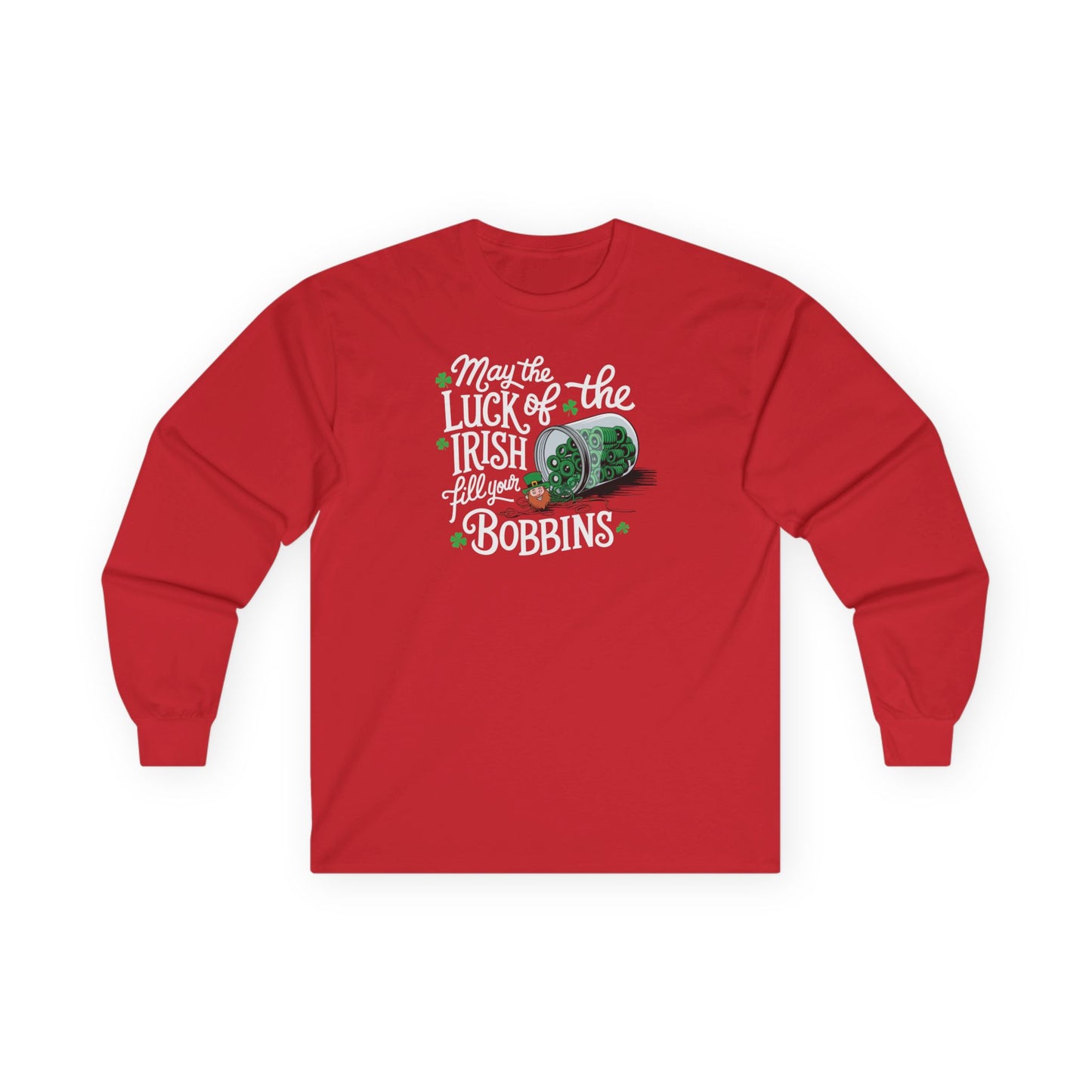 A Red long-sleeve t-shirt featuring a festive design with shamrocks, a spool of green thread, and the phrase 'May the Luck of the Irish Fill Your Bobbins,' perfect for quilters celebrating St. Patrick’s Day.