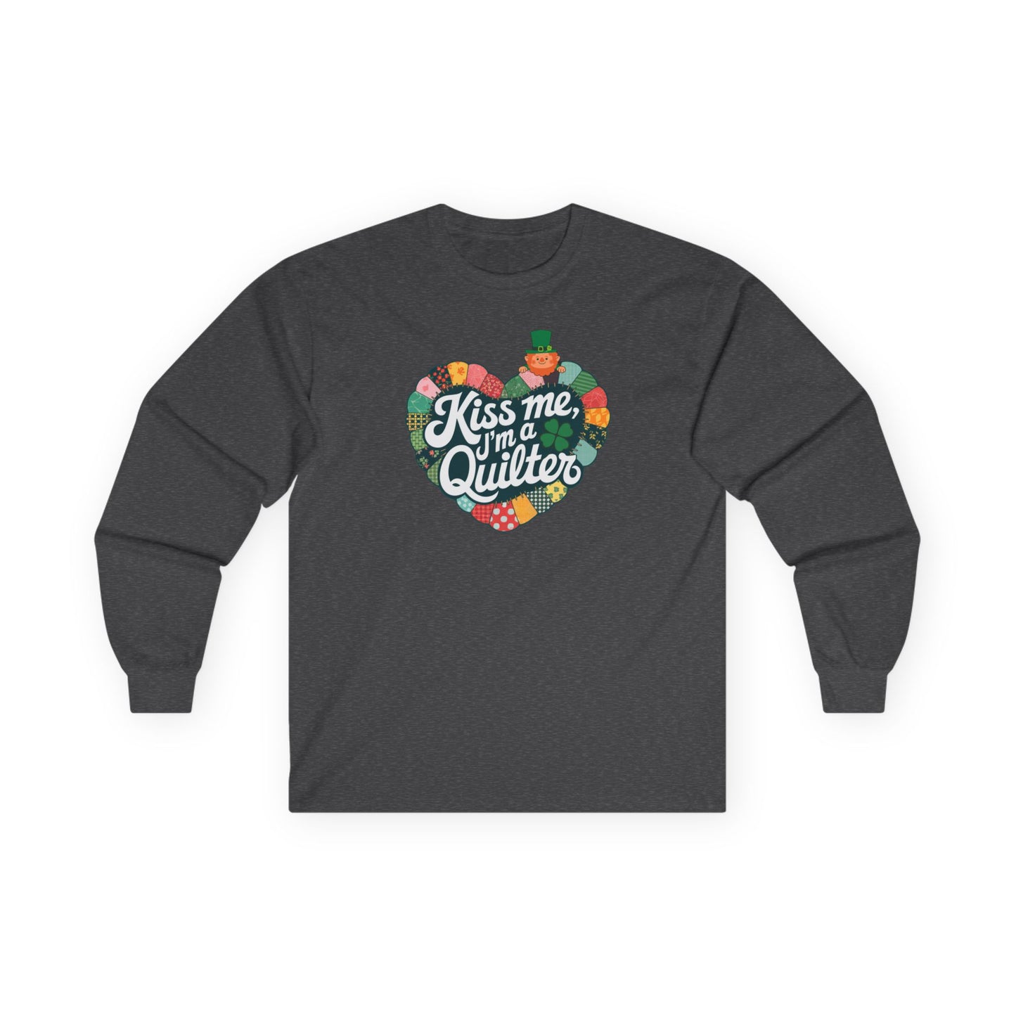 A Dark Heather long-sleeve t-shirt featuring a heart-shaped patchwork quilt design with shamrocks, a leprechaun, and the phrase 'Kiss Me, I’m a Quilter,' perfect for St. Patrick’s Day quilting fun.