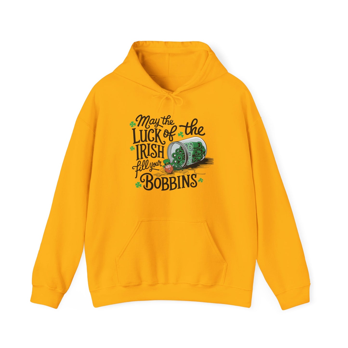 A Gold hoodie featuring a festive design with shamrocks, a spool of green thread, and the phrase 'May the Luck of the Irish Fill Your Bobbins,' perfect for quilters celebrating St. Patrick’s Day.