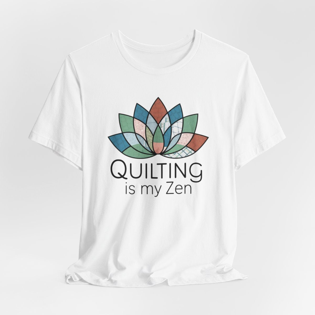 A White funny quilting T-Shirt with the phrase Quilting is my Zen on a quilting-themed t-shirt with a lotus flower design made of various quilt patterns and textures. 