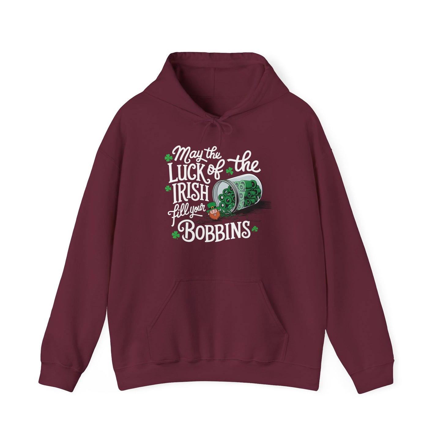 A Maroon hoodie featuring a festive design with shamrocks, a spool of green thread, and the phrase 'May the Luck of the Irish Fill Your Bobbins,' perfect for quilters celebrating St. Patrick’s Day.