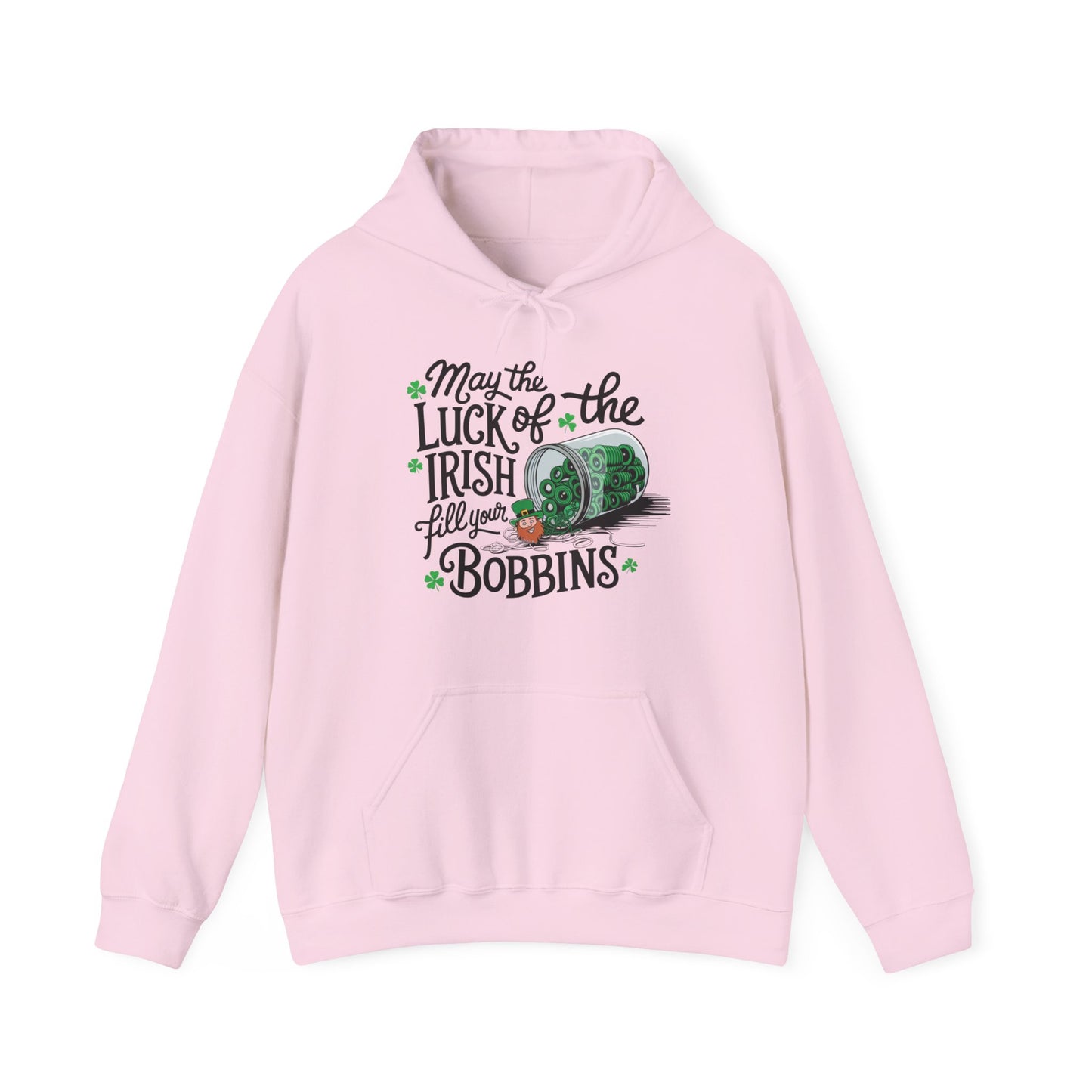 A Light Pink hoodie featuring a festive design with shamrocks, a spool of green thread, and the phrase 'May the Luck of the Irish Fill Your Bobbins,' perfect for quilters celebrating St. Patrick’s Day.