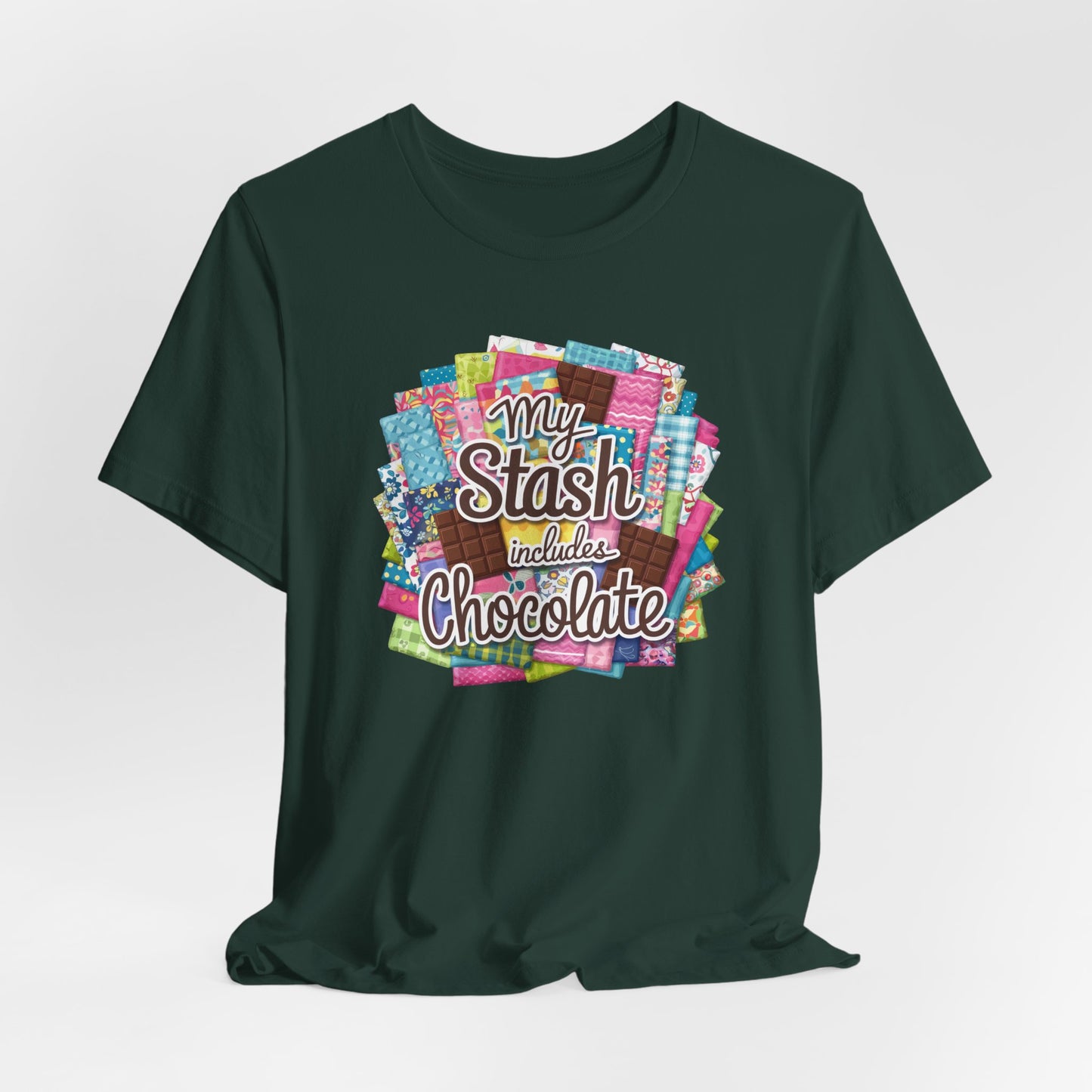 A Forest t-shirt featuring a colorful design of a fabric stash mixed with chocolate bars and the phrase 'My Stash Includes Chocolate,' perfect for quilters and chocolate lovers