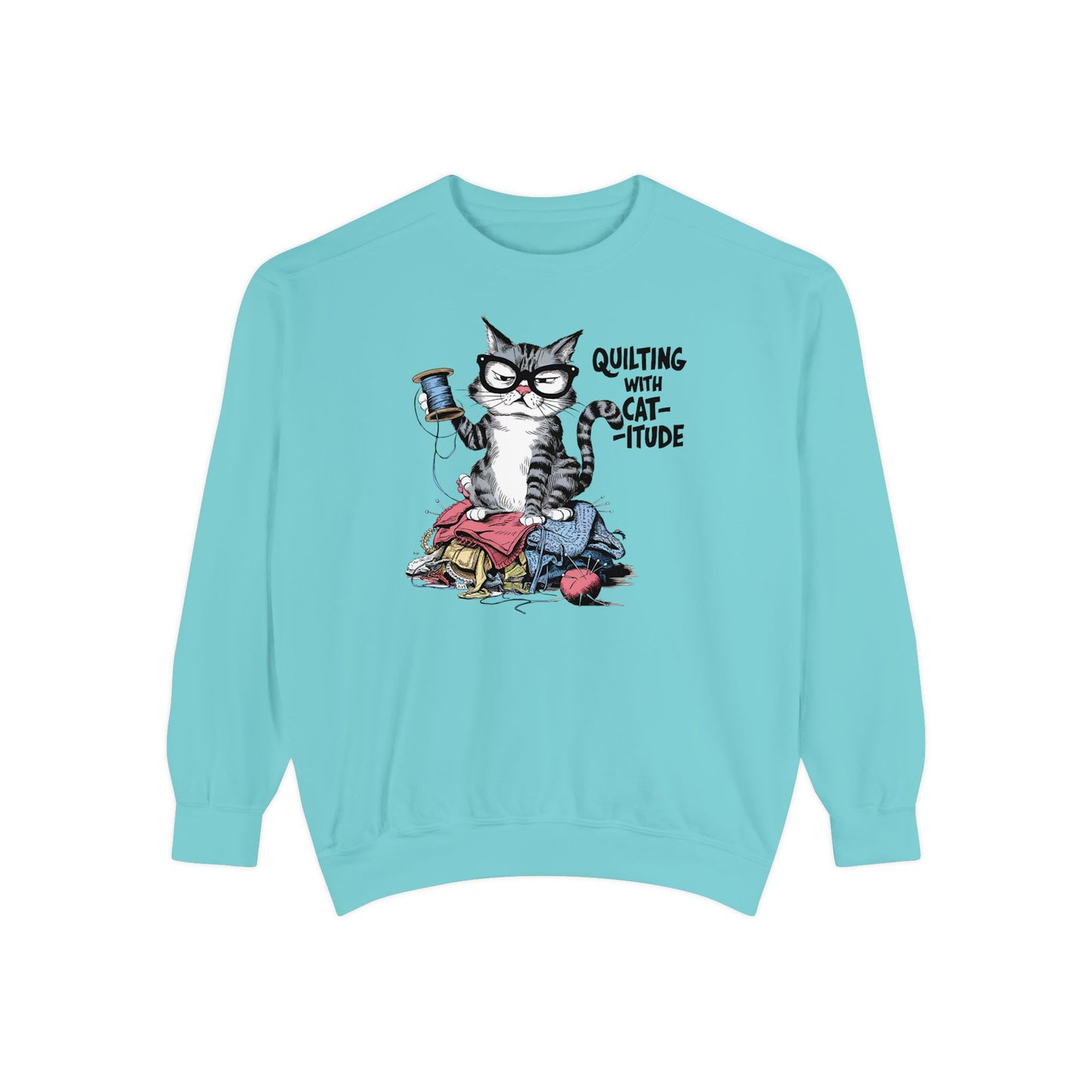 A Chalky Mint sweatshirt featuring a sassy cartoon cat sitting on a pile of colorful fabric, holding a spool of thread, with the phrase 'Quilting with Cat-itude,' perfect for quilters and cat lovers.