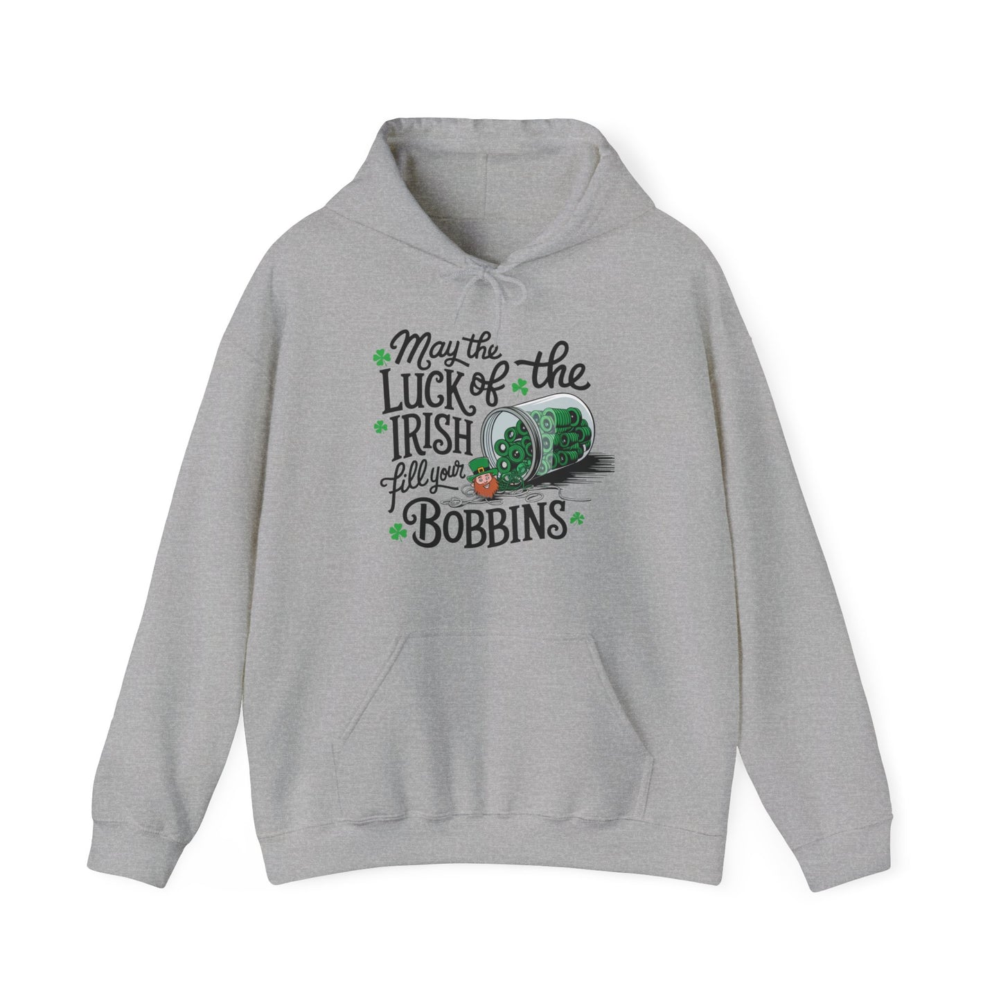 A Sport Grey hoodie featuring a festive design with shamrocks, a spool of green thread, and the phrase 'May the Luck of the Irish Fill Your Bobbins,' perfect for quilters celebrating St. Patrick’s Day.