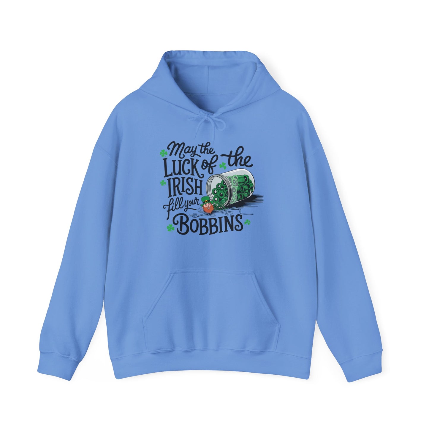 A Carolina Blue hoodie featuring a festive design with shamrocks, a spool of green thread, and the phrase 'May the Luck of the Irish Fill Your Bobbins,' perfect for quilters celebrating St. Patrick’s Day.