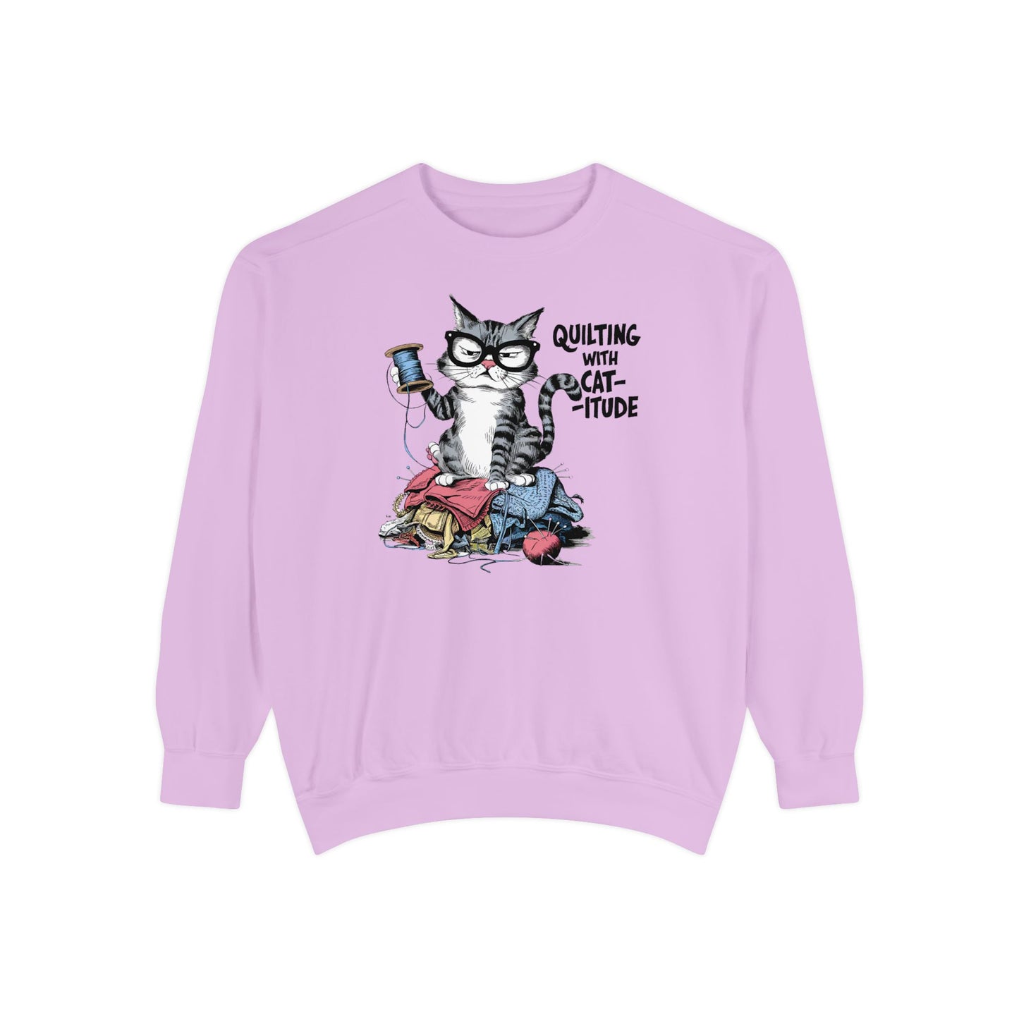 An Orchid sweatshirt featuring a sassy cartoon cat sitting on a pile of colorful fabric, holding a spool of thread, with the phrase 'Quilting with Cat-itude,' perfect for quilters and cat lovers.