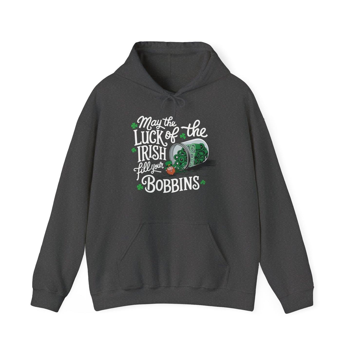 A Dark Heather hoodie featuring a festive design with shamrocks, a spool of green thread, and the phrase 'May the Luck of the Irish Fill Your Bobbins,' perfect for quilters celebrating St. Patrick’s Day.