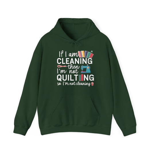 A Forest Green funny Hoodie with the phrase If I am Cleaning then I'm not Quilting in a bold and cheerful font with images of quilting icons and supplies