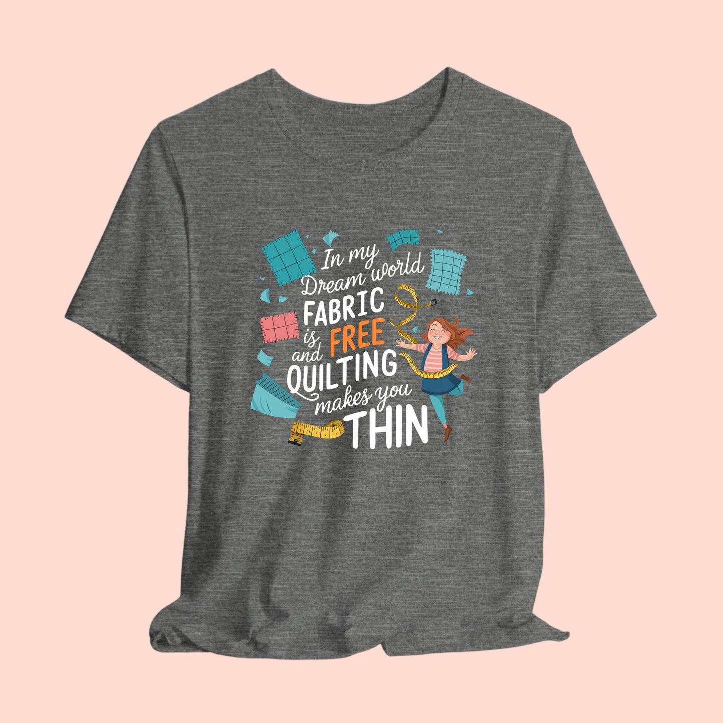 A funny quilting T-Shirt with the phrase Fabric is Free and Quilting Makes You Thin in a fun font with a cheerful quilter jumping for joy