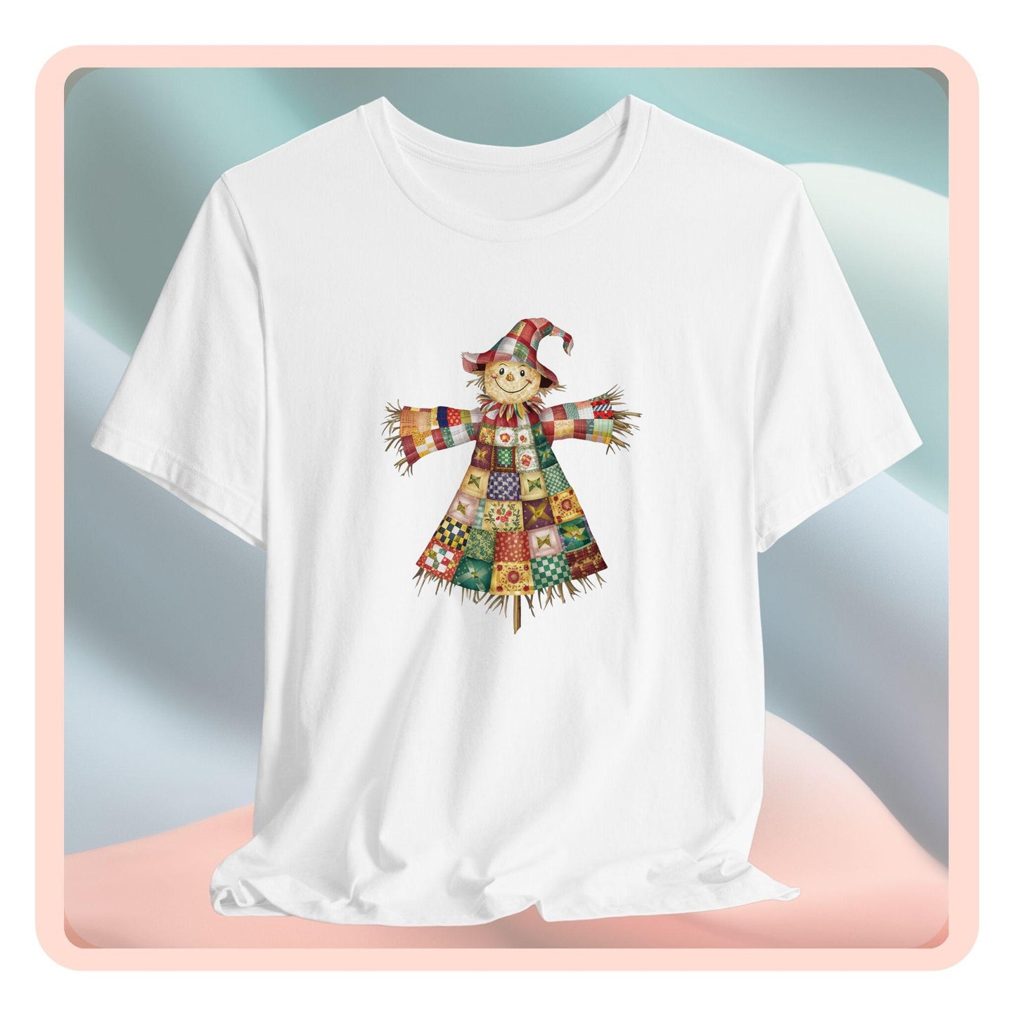 A thanksgiving  quilting t-shirt featuring a smiling scarecrow made entirely of colorful quilt patterns. Wearing a patchwork hat and clothes with various quilt designs. Straw details on hands and neck. Cheerful autumn-themed illustration celebrating quilting craft.