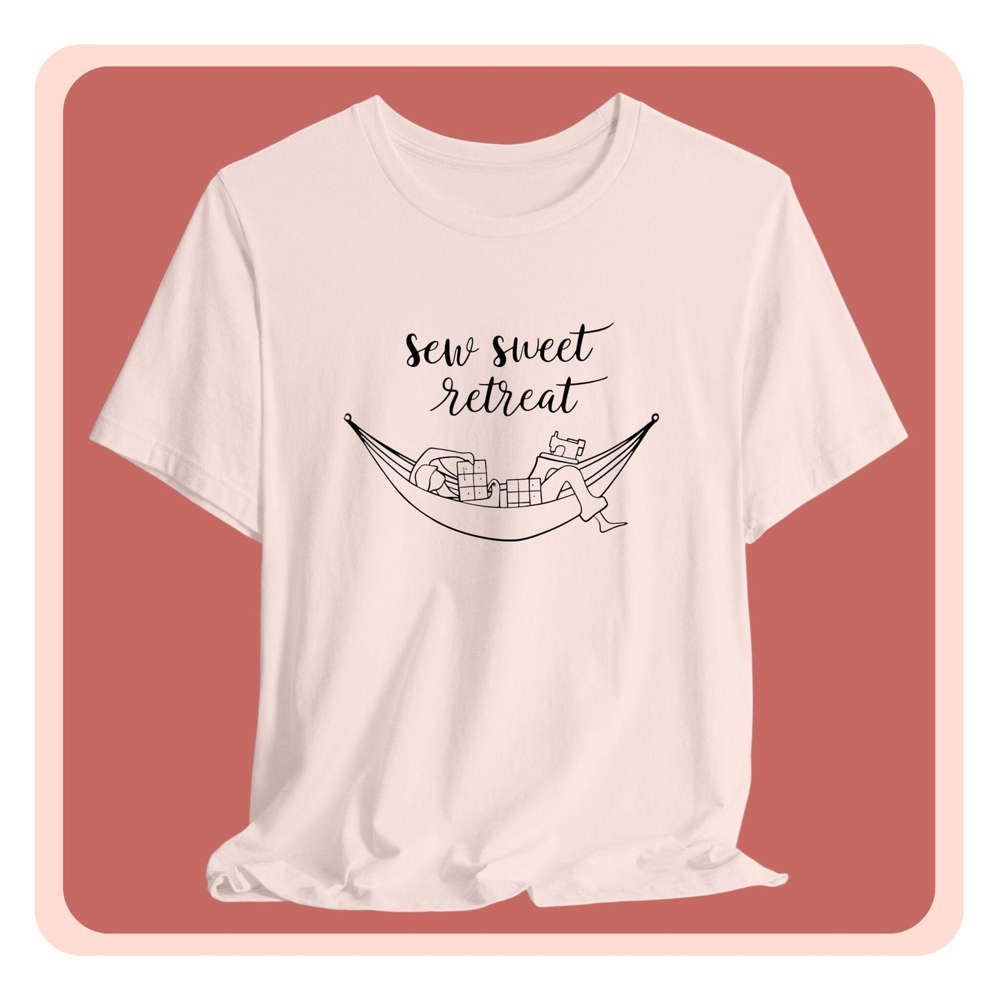 A T-Shirt with a black and white illustration of a hammock filled with quilting supplies like fabric squares and a sewing machine. Text above reads "Sew Sweet Retreat" in a flowing script font.