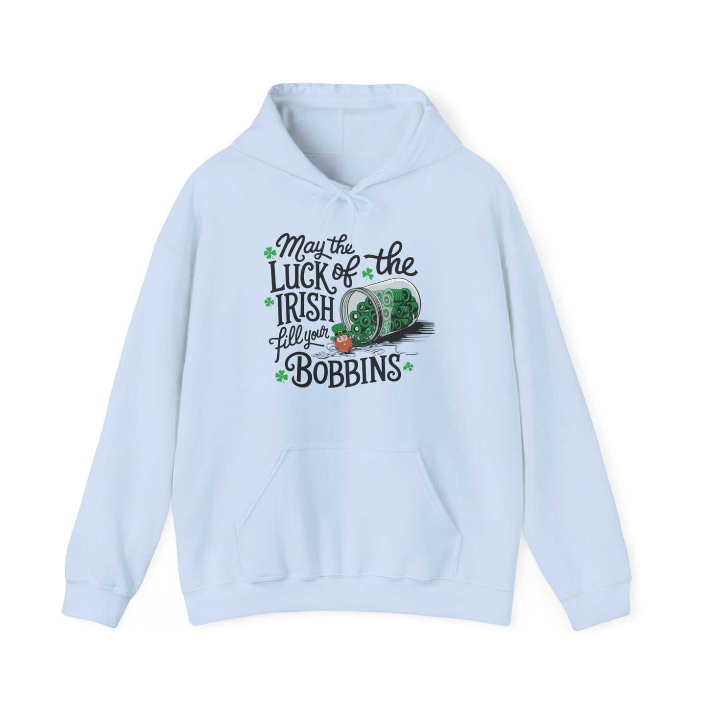 A Light Blue hoodie featuring a festive design with shamrocks, a spool of green thread, and the phrase 'May the Luck of the Irish Fill Your Bobbins,' perfect for quilters celebrating St. Patrick’s Day.