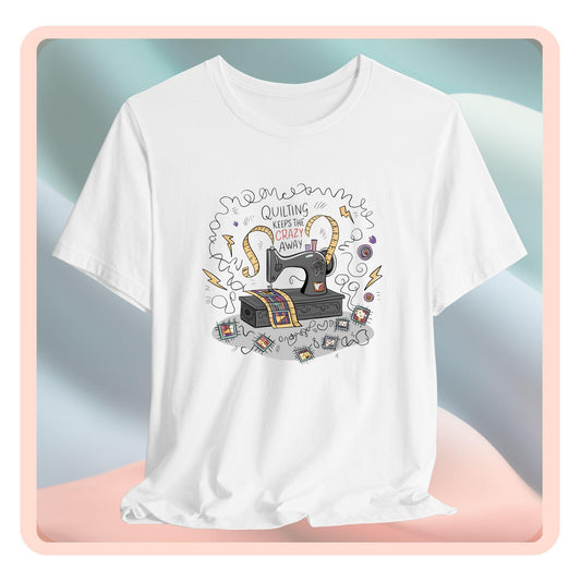 A T-Shirt with a vintage sewing machine, measuring tape heart, and text "Quilting Keeps the Crazy Away" amidst swirls and quilting motifs.