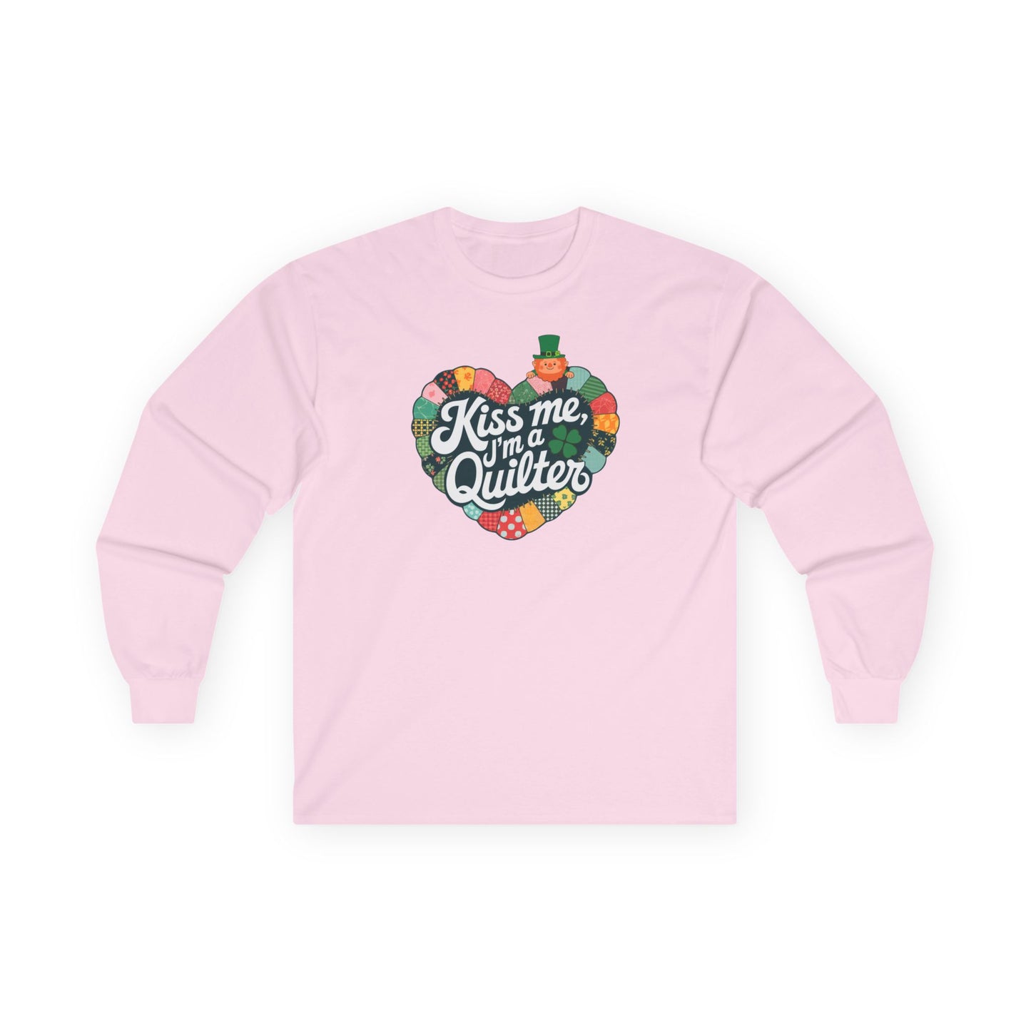 A Light Pink long-sleeve t-shirt featuring a heart-shaped patchwork quilt design with shamrocks, a leprechaun, and the phrase 'Kiss Me, I’m a Quilter,' perfect for St. Patrick’s Day quilting fun.