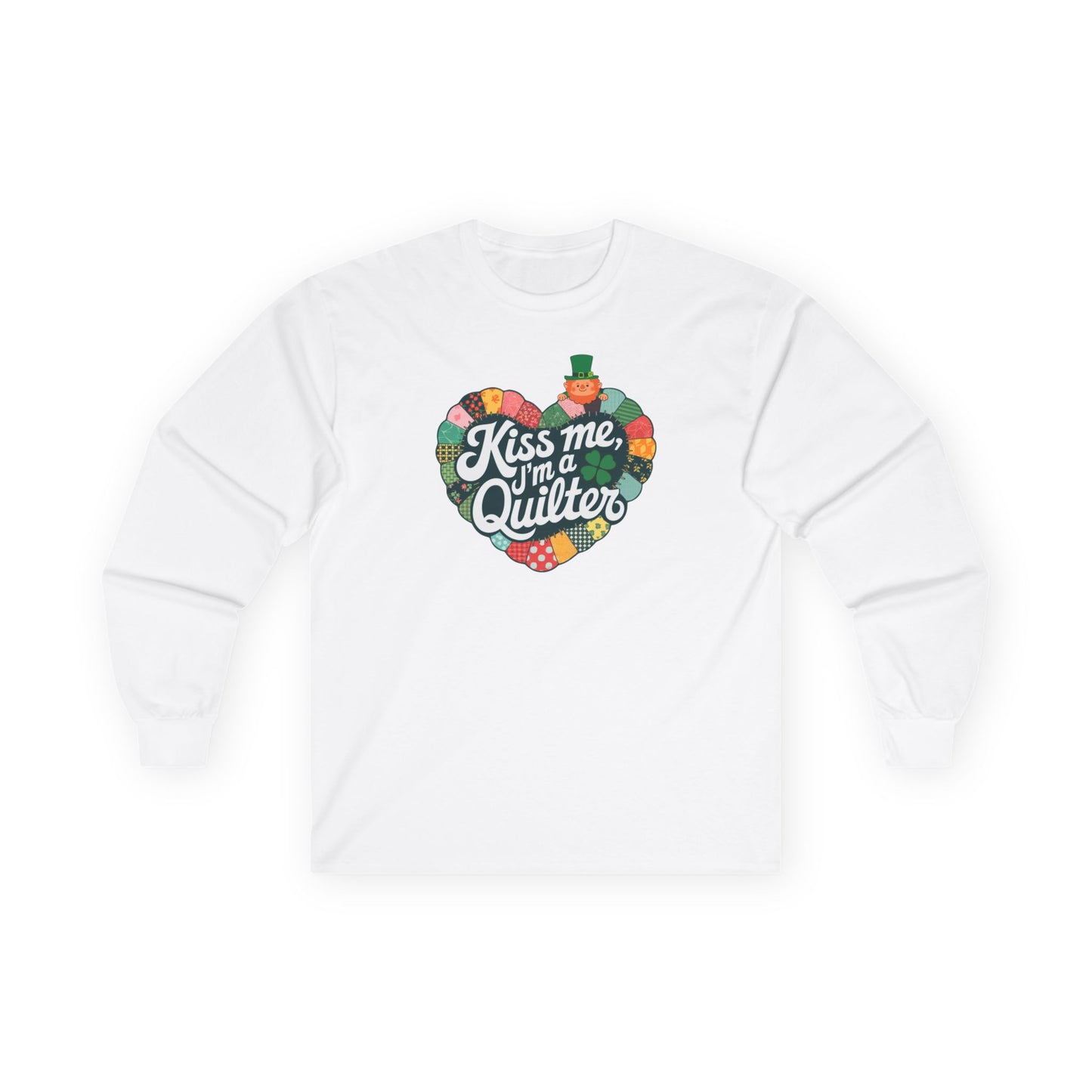 A White long-sleeve t-shirt featuring a heart-shaped patchwork quilt design with shamrocks, a leprechaun, and the phrase 'Kiss Me, I’m a Quilter,' perfect for St. Patrick’s Day quilting fun.