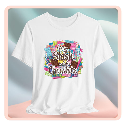 A t-shirt featuring a colorful design of a fabric stash mixed with chocolate bars and the phrase 'My Stash Includes Chocolate,' perfect for quilters and chocolate lovers