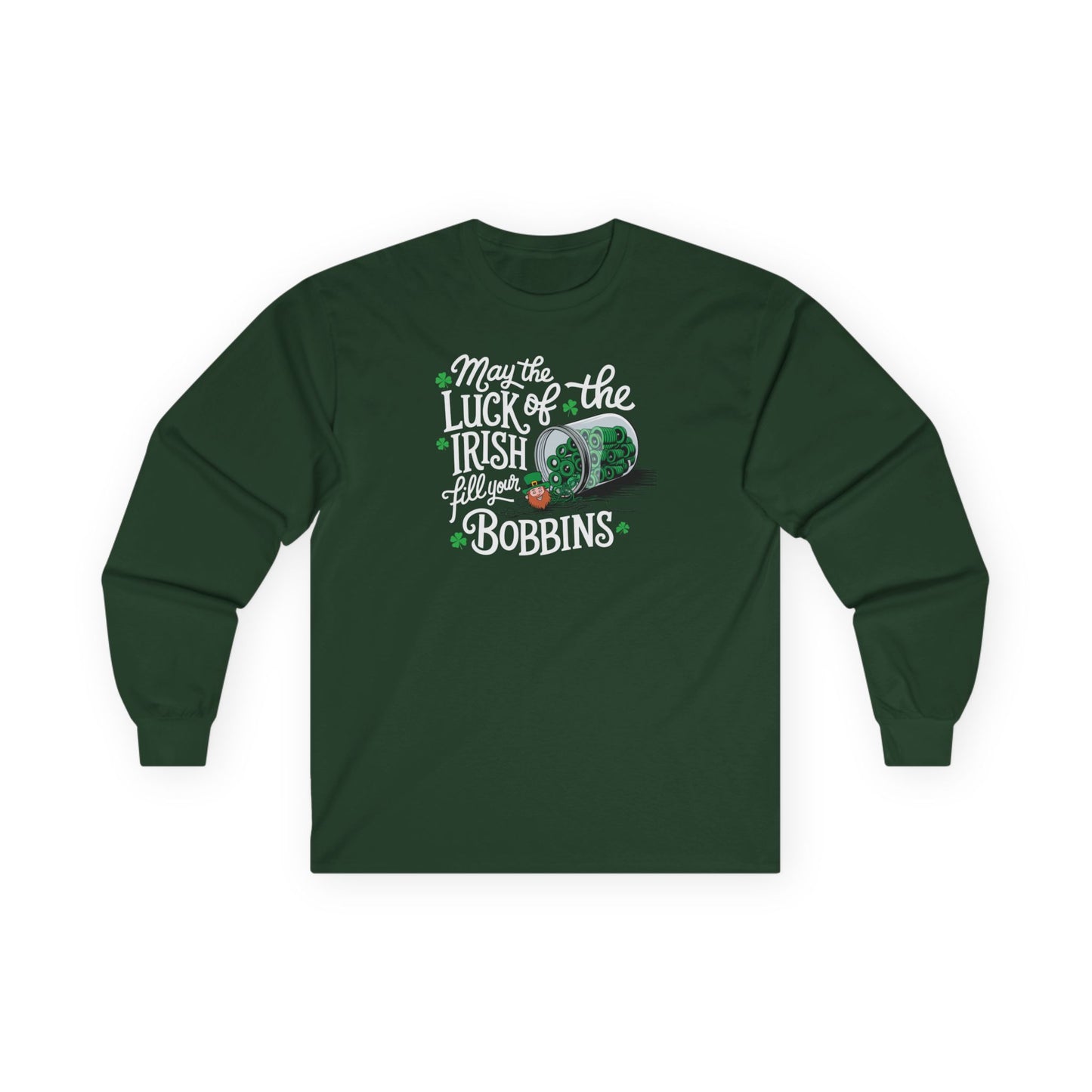 A Forest Green long-sleeve t-shirt featuring a festive design with shamrocks, a spool of green thread, and the phrase 'May the Luck of the Irish Fill Your Bobbins,' perfect for quilters celebrating St. Patrick’s Day.