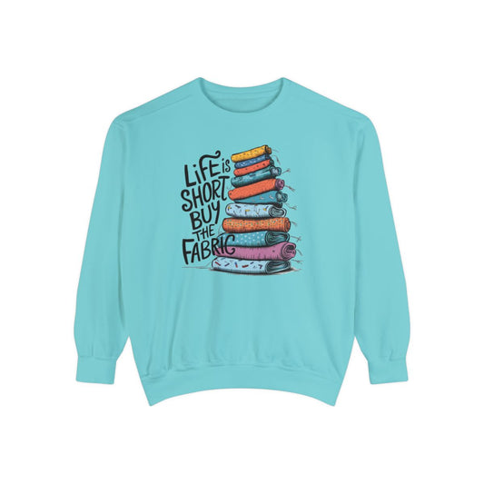 A Chalky Mint funny Sweatshirt with the phrase Life is Short, Buy the Fabric with the label 'Life is Short, Buy the Fabric' next to a graphic of pile of fabric