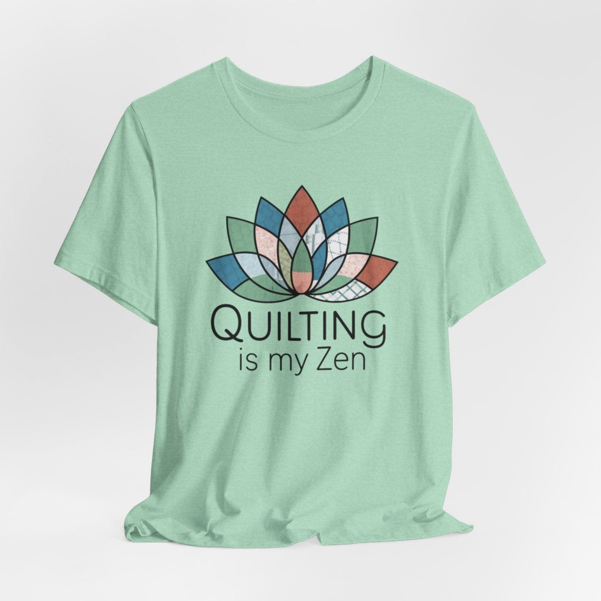 A Heather Mint funny quilting T-Shirt with the phrase Quilting is my Zen on a quilting-themed t-shirt with a lotus flower design made of various quilt patterns and textures. 