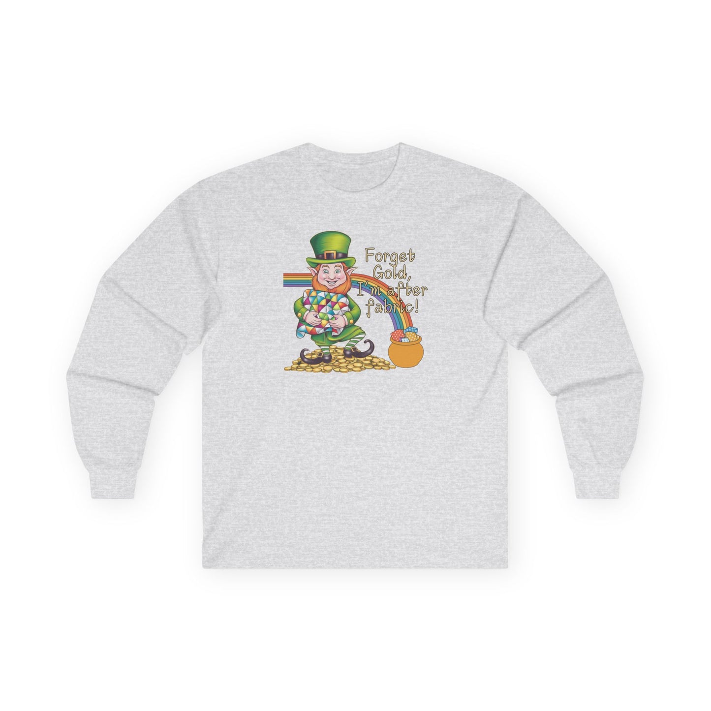 An Ash long-sleeve t-shirt featuring a cheerful leprechaun holding a quilt, sitting on gold coins, with a rainbow leading to a fabric-filled pot and the phrase 'Forget Gold, I’m After Fabric!' Perfect for quilters celebrating St. Patrick’s Day.