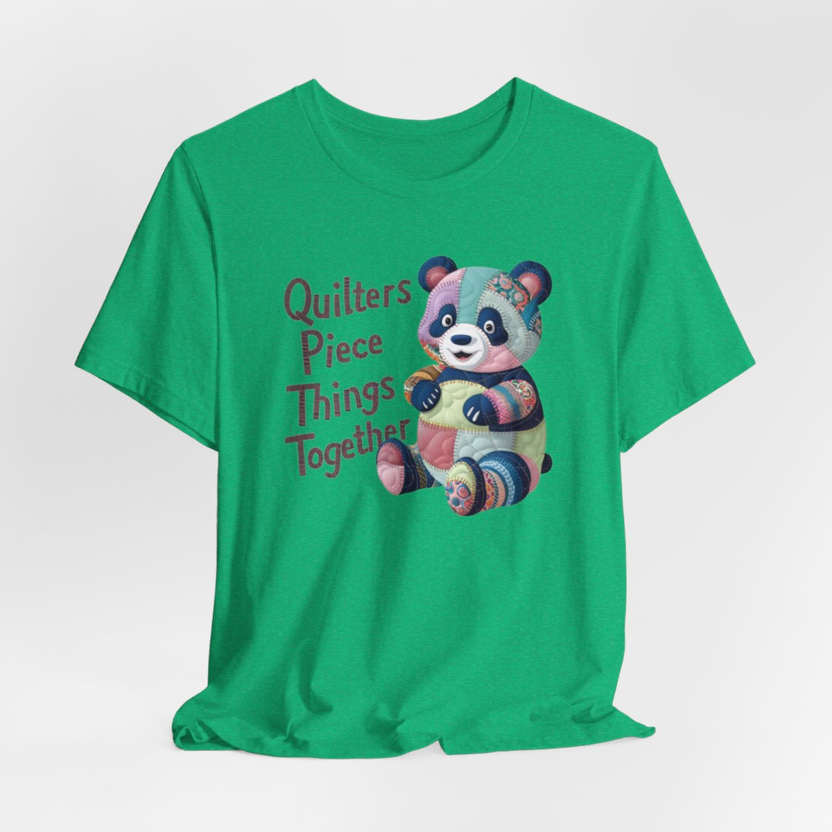 A Heather Kelly fun T-Shirt with the phrase Quilters Piece Things Together with a patchwork panda design . The panda is made of colorful fabric scraps stitched together, creating a whimsical and crafty appearance. Perfect for quilting enthusiasts with a sense of humor.