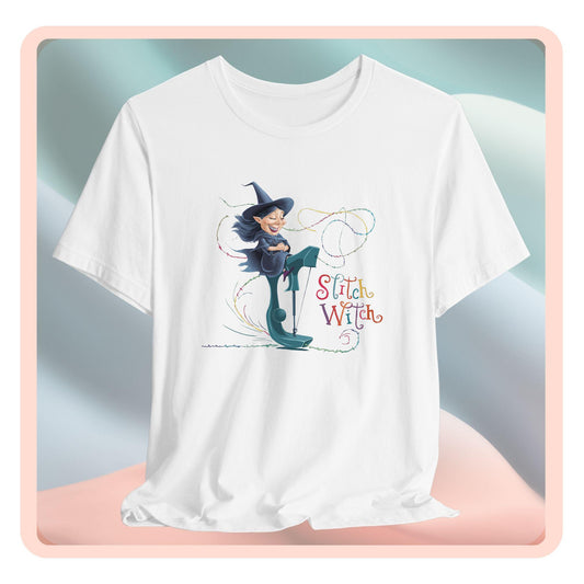 A T-shirt with a cartoon illustration of a smiling witch with pointed hat riding a teal sewing machine. Colorful stitches swirl around her in the air. Text reads "Stitch Witch" in playful, multicolored letters.