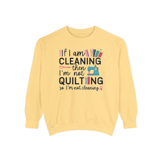 A Butter funny Sweatshirt with the phrase If I am Cleaning then I'm not Quilting in a bold and cheerful font with images of quilting icons and supplies