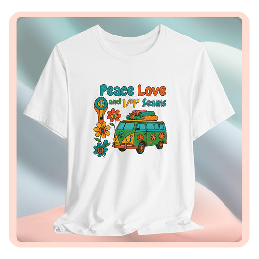 A A t-shirt with colorful retro design showing a peace sign rotary cutter, patchwork van, and text “Peace Love and 1/4" Seams.” Surrounded by flowers made of thread spools. Fun vintage-style quilting shirt.