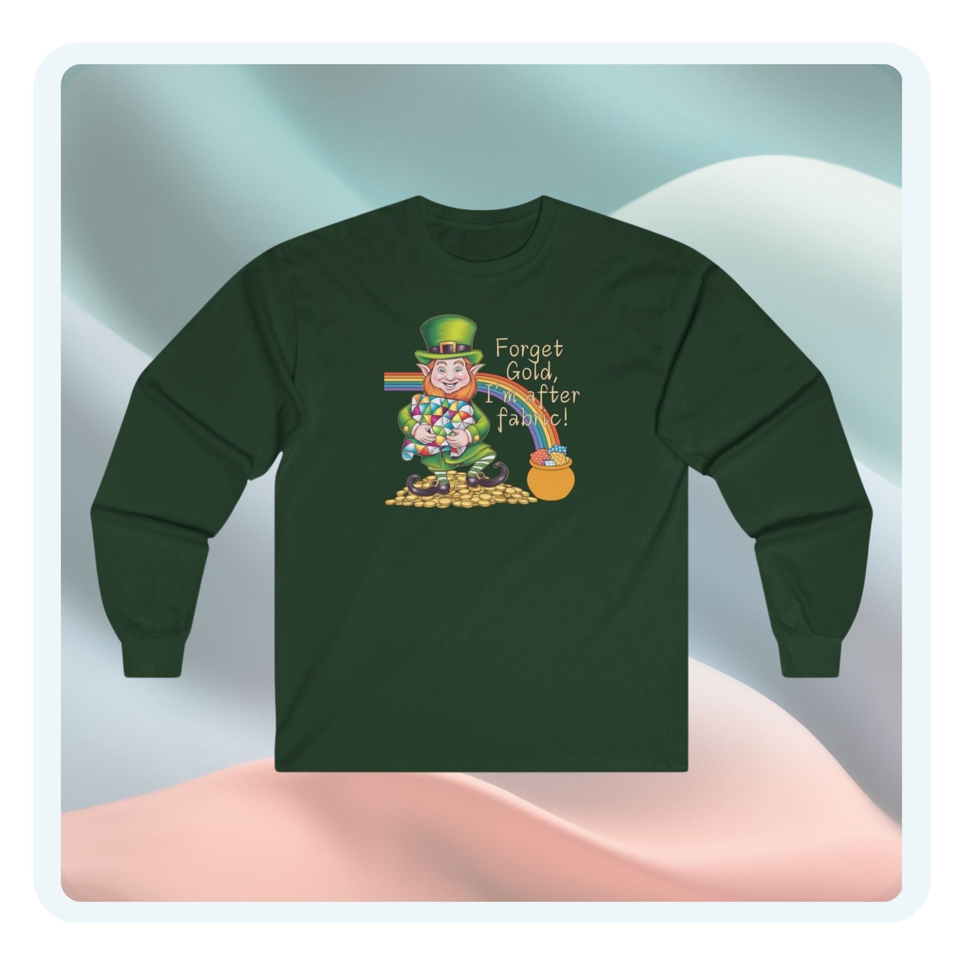 A long-sleeve t-shirt featuring a cheerful leprechaun holding a quilt, sitting on gold coins, with a rainbow leading to a fabric-filled pot and the phrase 'Forget Gold, I’m After Fabric!' Perfect for quilters celebrating St. Patrick’s Day.