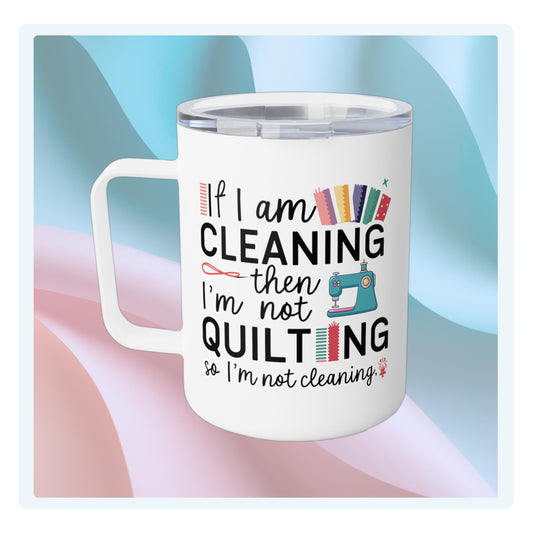 A funny quilting-inspired Insulated Mug with the phrase If I am Cleaning then I'm not Quilting in a bold and cheerful font with images of quilting icons and supplies