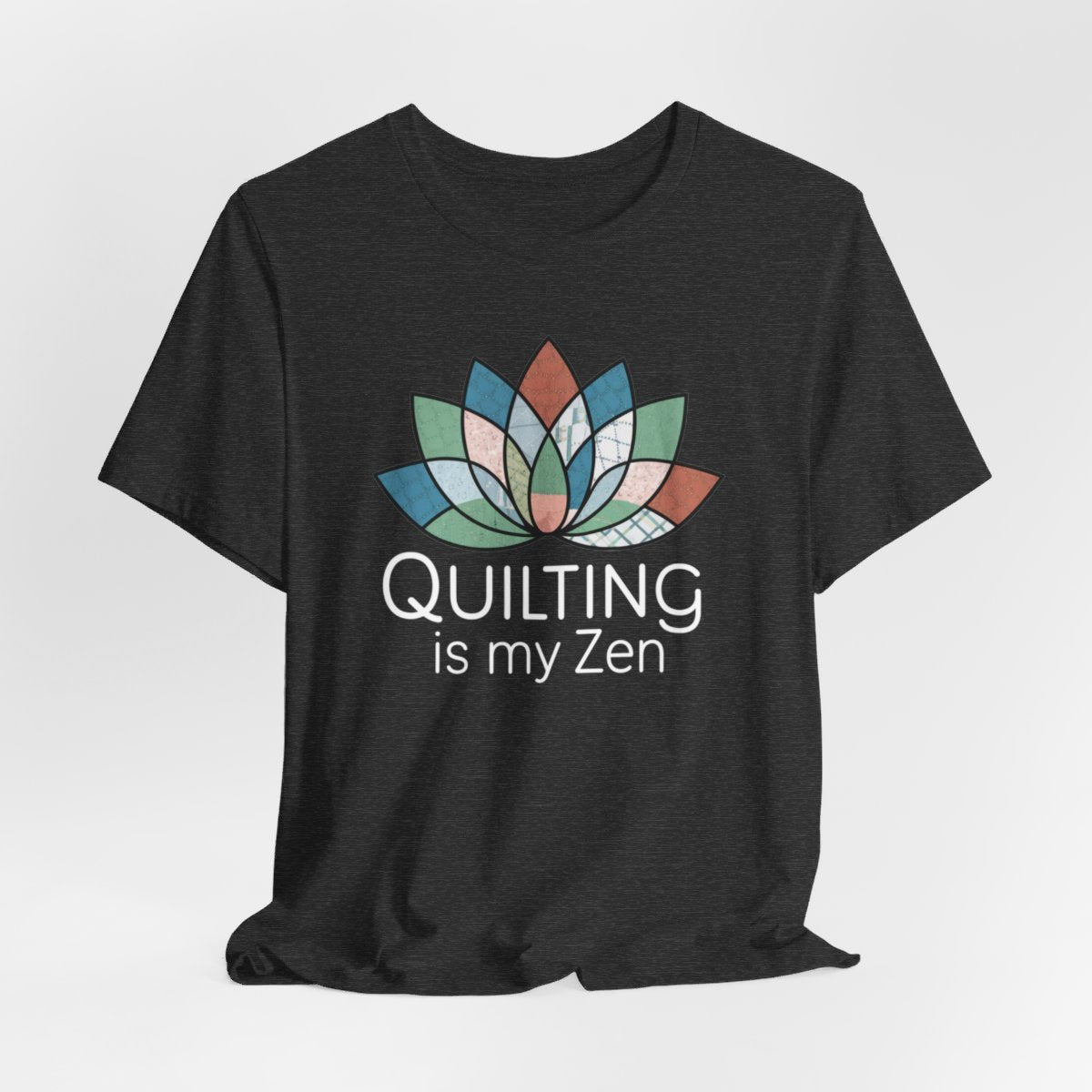 A Dark Grey Heather funny quilting T-Shirt with the phrase Quilting is my Zen on a quilting-themed t-shirt with a lotus flower design made of various quilt patterns and textures. 