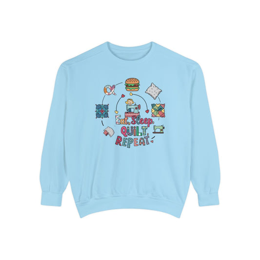 A Chambray funny Sweatshirt with the phrase Eat, Sleep, Quilt, Repeat  showing the cycle of a quilter's day with eating, sleeping, and quilting