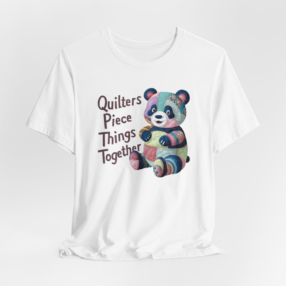 A White fun T-Shirt with the phrase Quilters Piece Things Together with a patchwork panda design . The panda is made of colorful fabric scraps stitched together, creating a whimsical and crafty appearance. Perfect for quilting enthusiasts with a sense of humor.