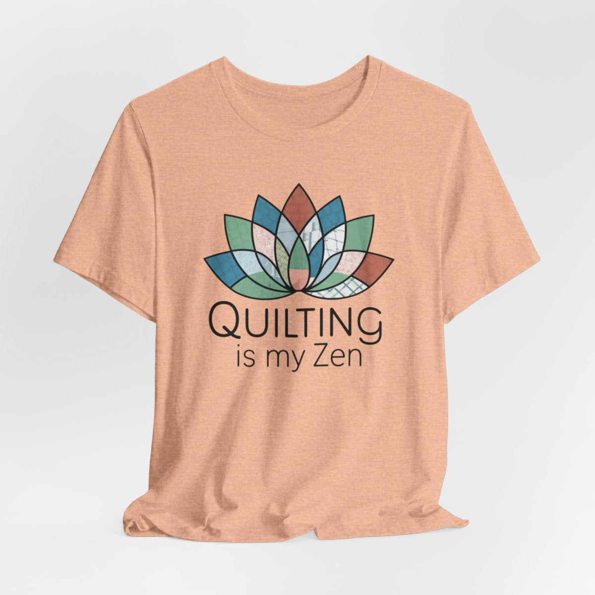 A Heather Peach funny quilting T-Shirt with the phrase Quilting is my Zen on a quilting-themed t-shirt with a lotus flower design made of various quilt patterns and textures. 