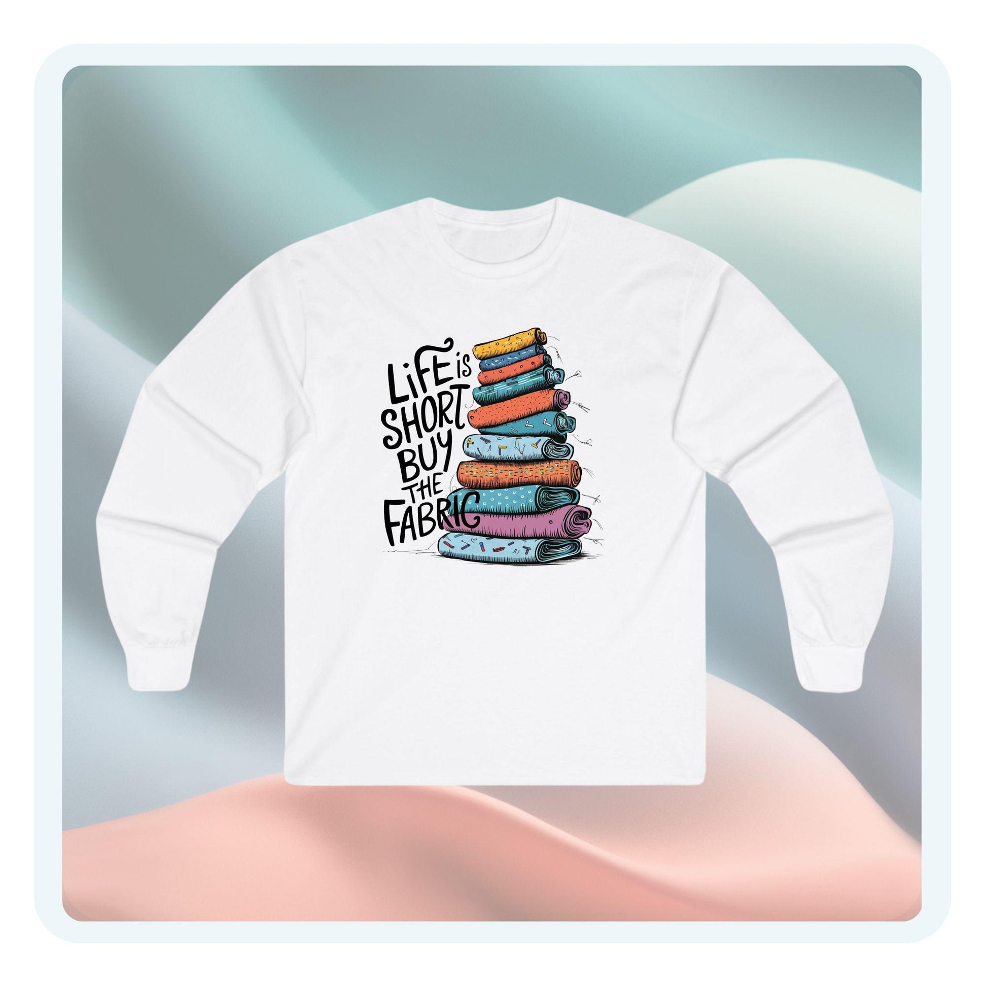 A long-sleeve t-shirt featuring a vibrant stack of colorful fabric rolls with the playful phrase 'Life Is Short, Buy the Fabric,' perfect for sewing and quilting enthusiasts