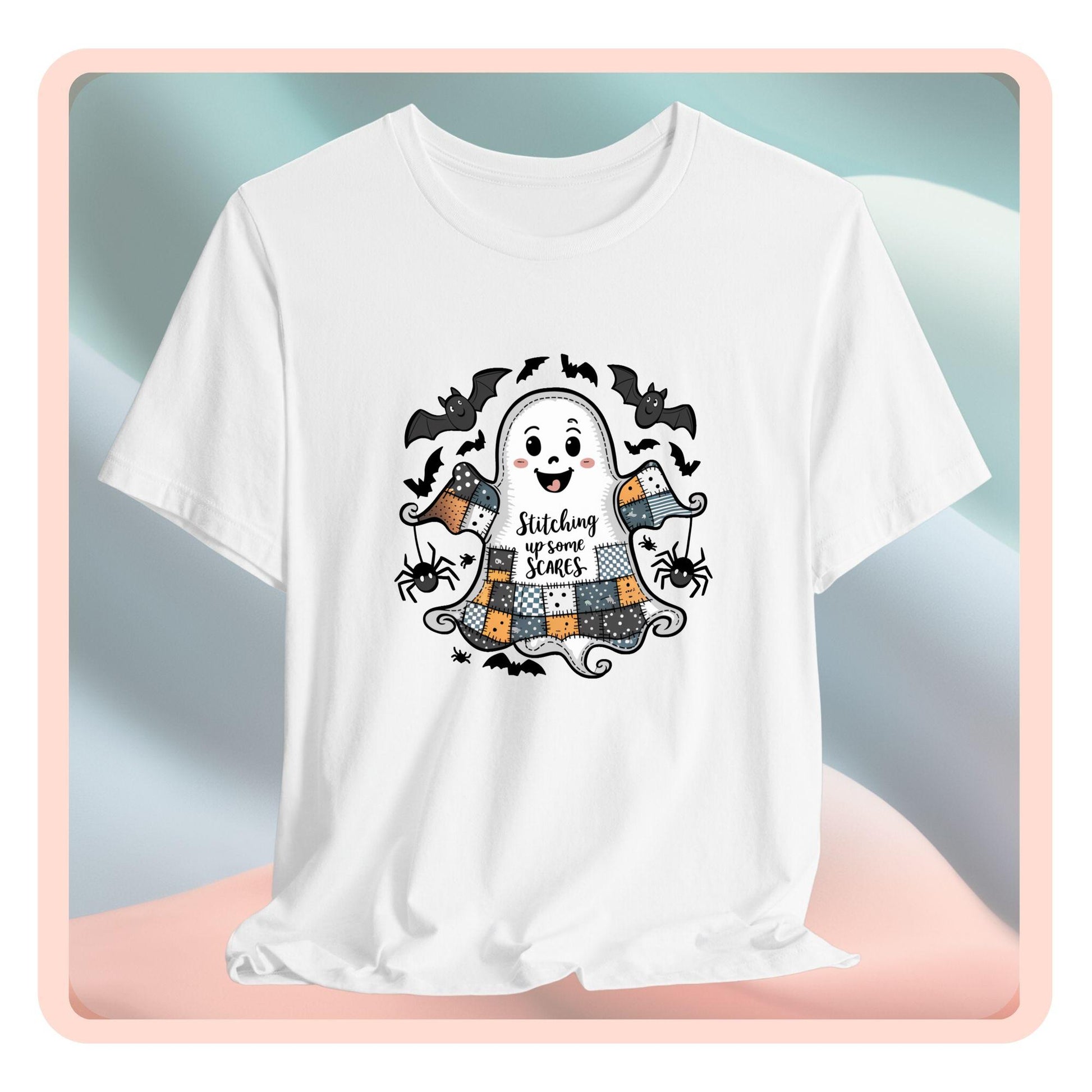 A Halloween Quilting T-Shirt featuring a smiling ghost with quilted patchwork body. Halloween-themed quilt patterns. Cute bats and spiders around ghost. Text reads "Stitching up some Scares". Ideal for quilters who enjoy Halloween themes.