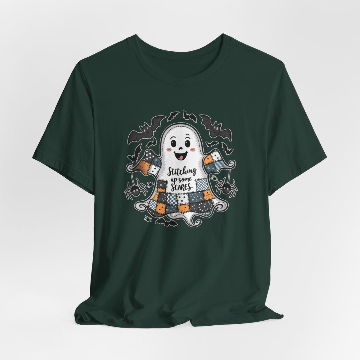 A Forest Halloween Quilting T-Shirt featuring a smiling ghost with quilted patchwork body. Halloween-themed quilt patterns. Cute bats and spiders around ghost. Text reads "Stitching up some Scares". Ideal for quilters who enjoy Halloween themes.