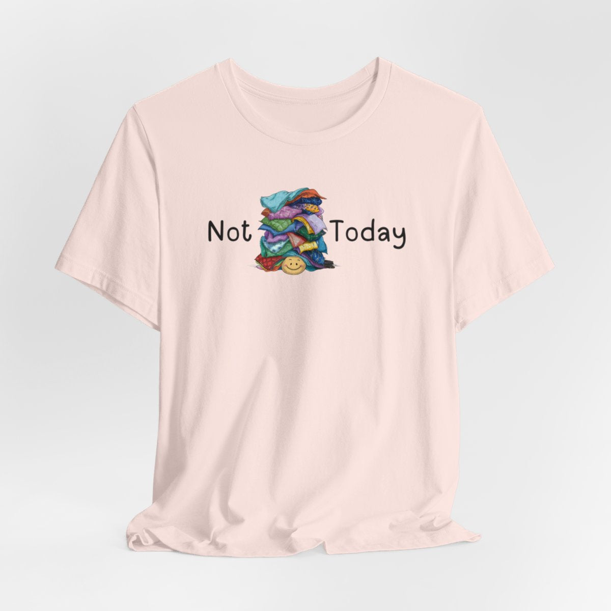 A Soft Pink funny quilting T-Shirt with the phrase Not Today showing an enormous pile of fabric on top of a cheerful quilter