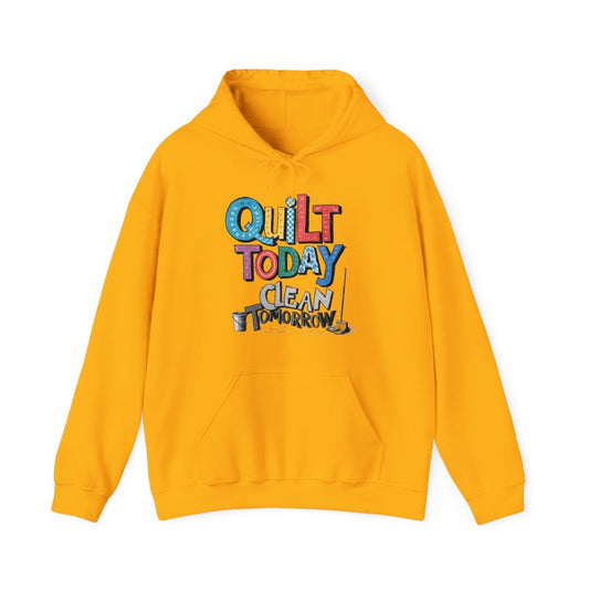 A Gold funny Hoodie with the phrase Quilt Today, Clean Tomorrow in a bold and cheerful font with a broom off to the side