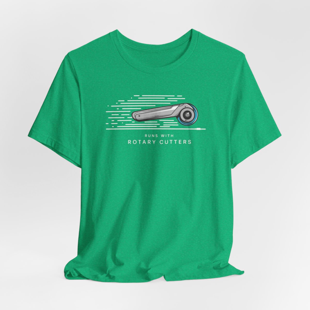 A Heather Kelly T-shirt featuring minimalist graphic of a sleek rotary cutter in motion with speed lines. Text below reads "RUNS WITH ROTARY CUTTERS" in a modern font.