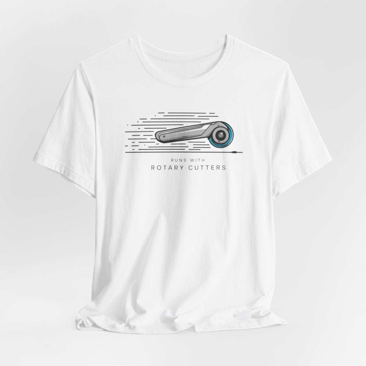 A White T-shirt featuring minimalist graphic of a sleek rotary cutter in motion with speed lines. Text below reads "RUNS WITH ROTARY CUTTERS" in a modern font.